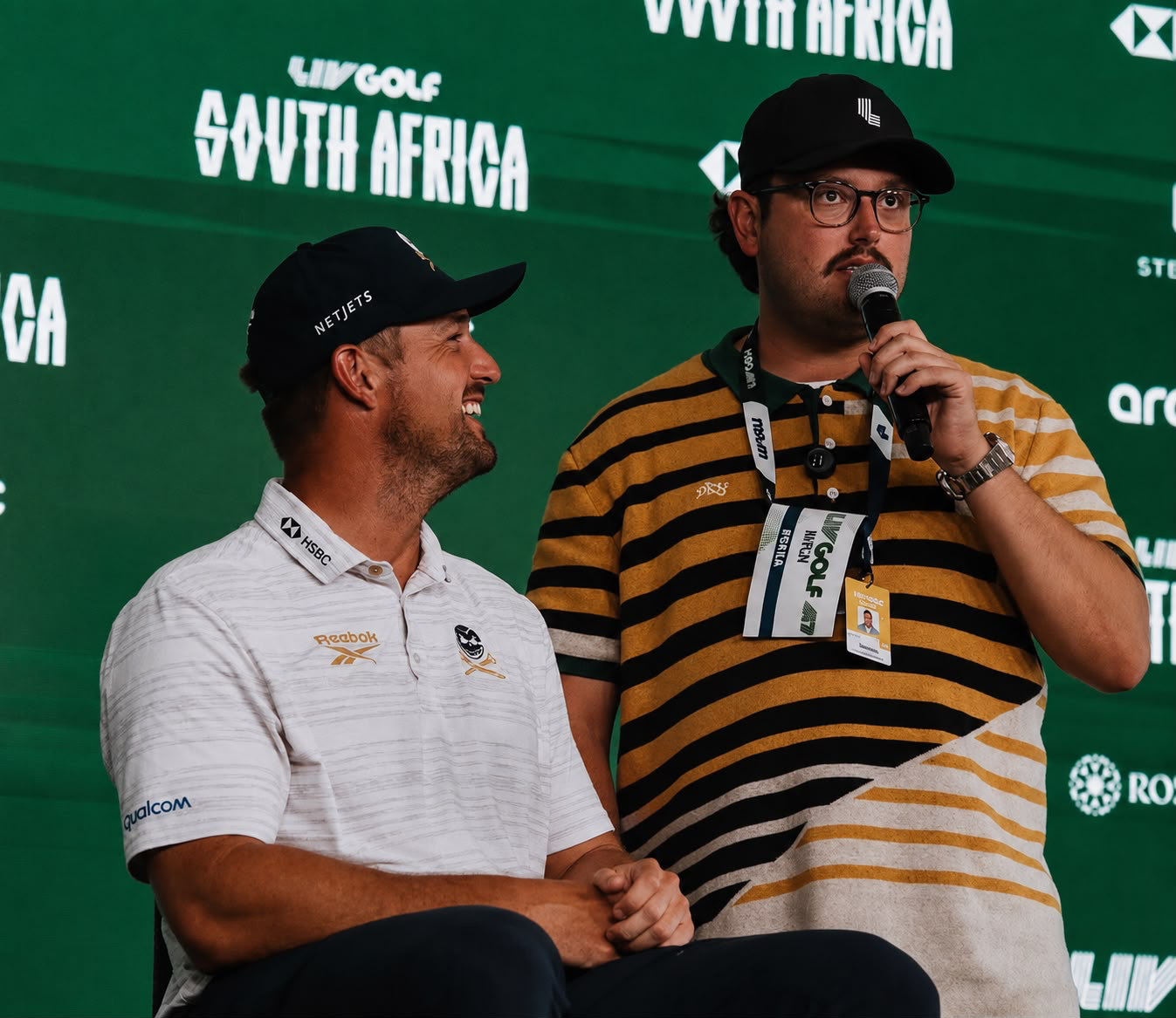 Dimitri Silly Goose speaking into a microphone beside a golfer at LIV Golf South Africa