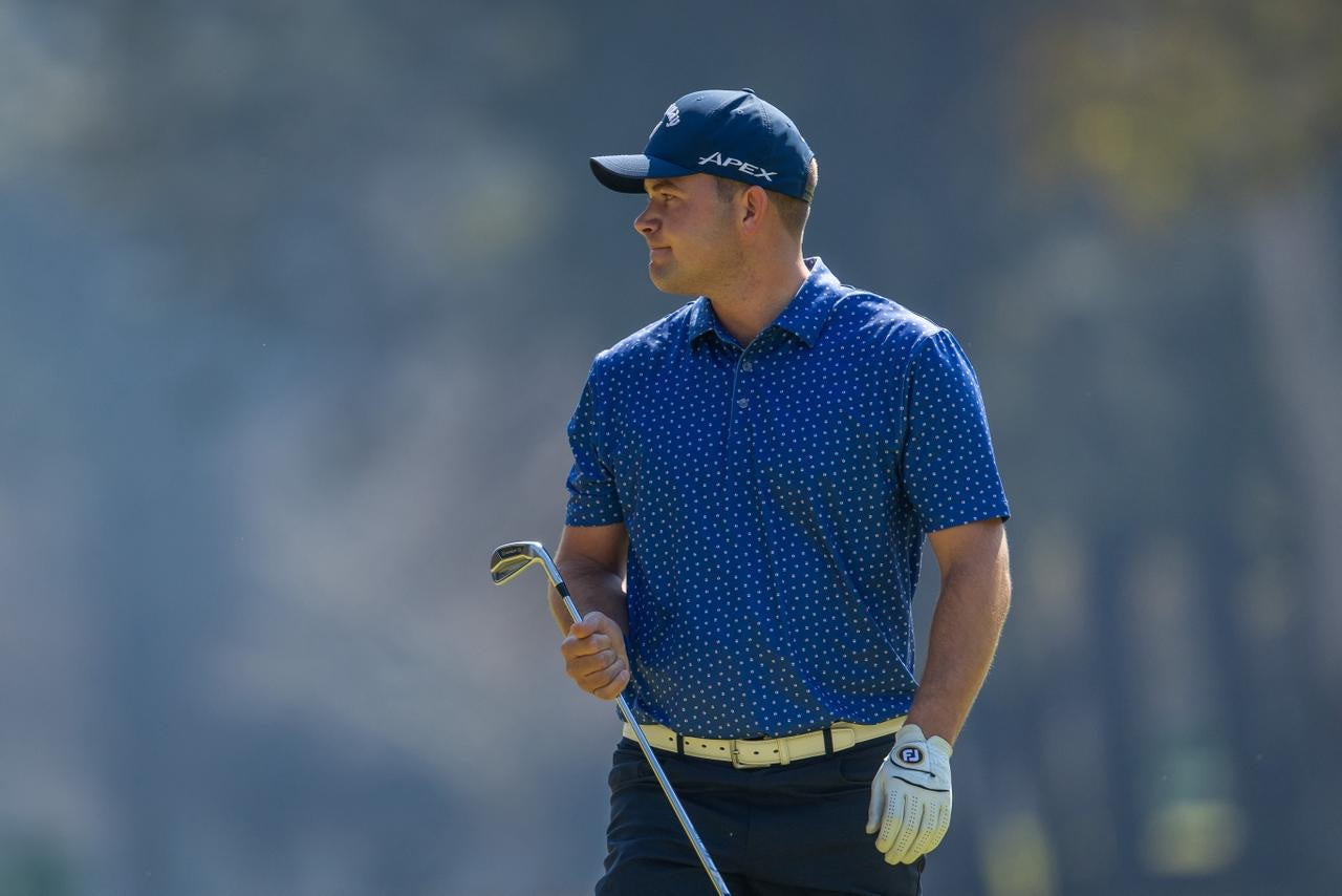 Herman Loubser holding an iron on the golf course