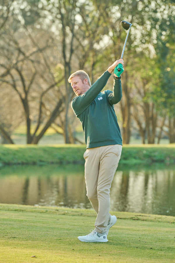 Jacques Blaauw swinging a golf club on the course