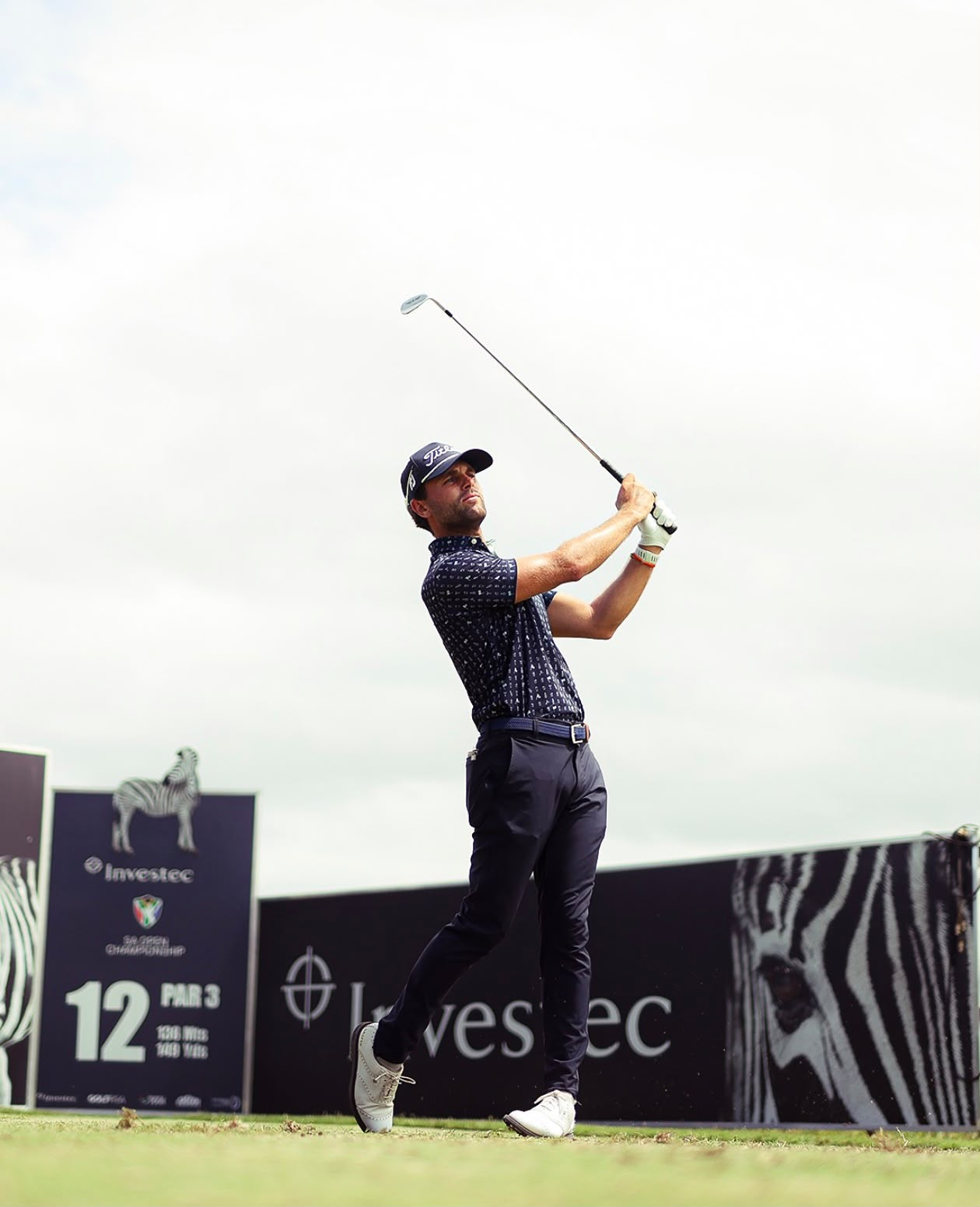 Kyle Barker following through on a golf shot