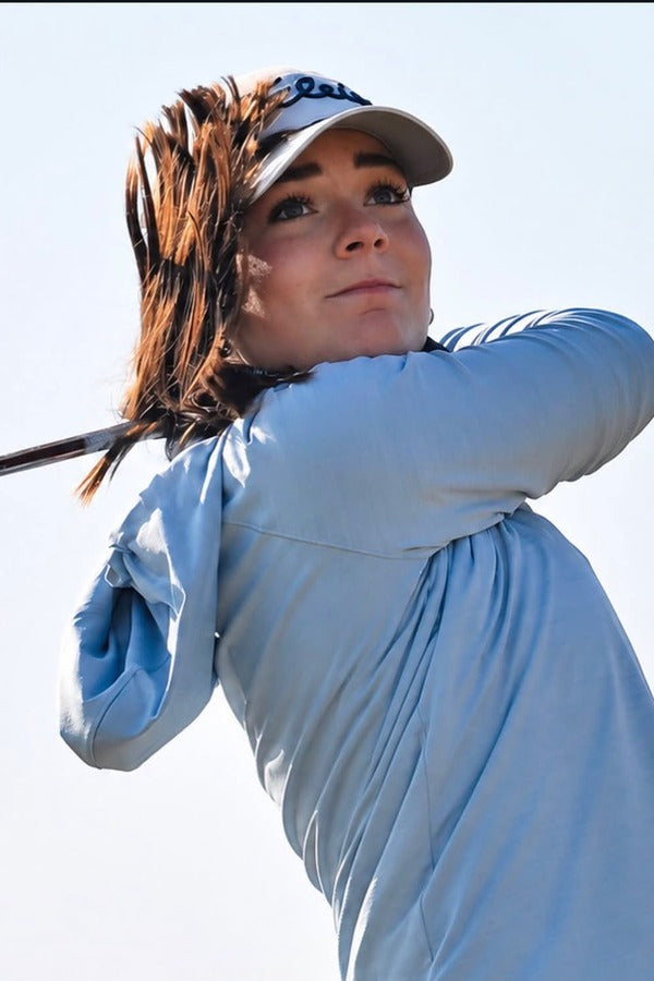 Maegan Webster following through on a golf swing